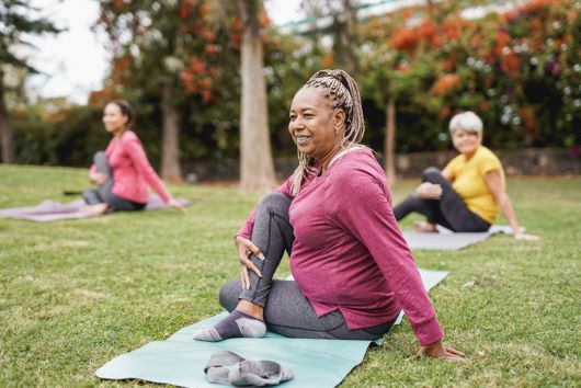 Group of women doing yoga outdoors