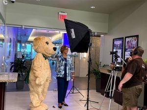 Cash posing with BayFirst team members during a visit to the St. Petersburg branch.