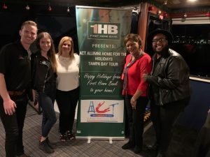 Party Like a Yacht Star event group photo with First Home Bank Happy Holidays banner