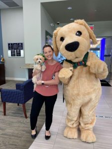 BayFirst employee and dog posing with mascot