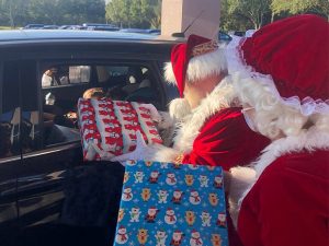 Christmas presents being handed to children in car