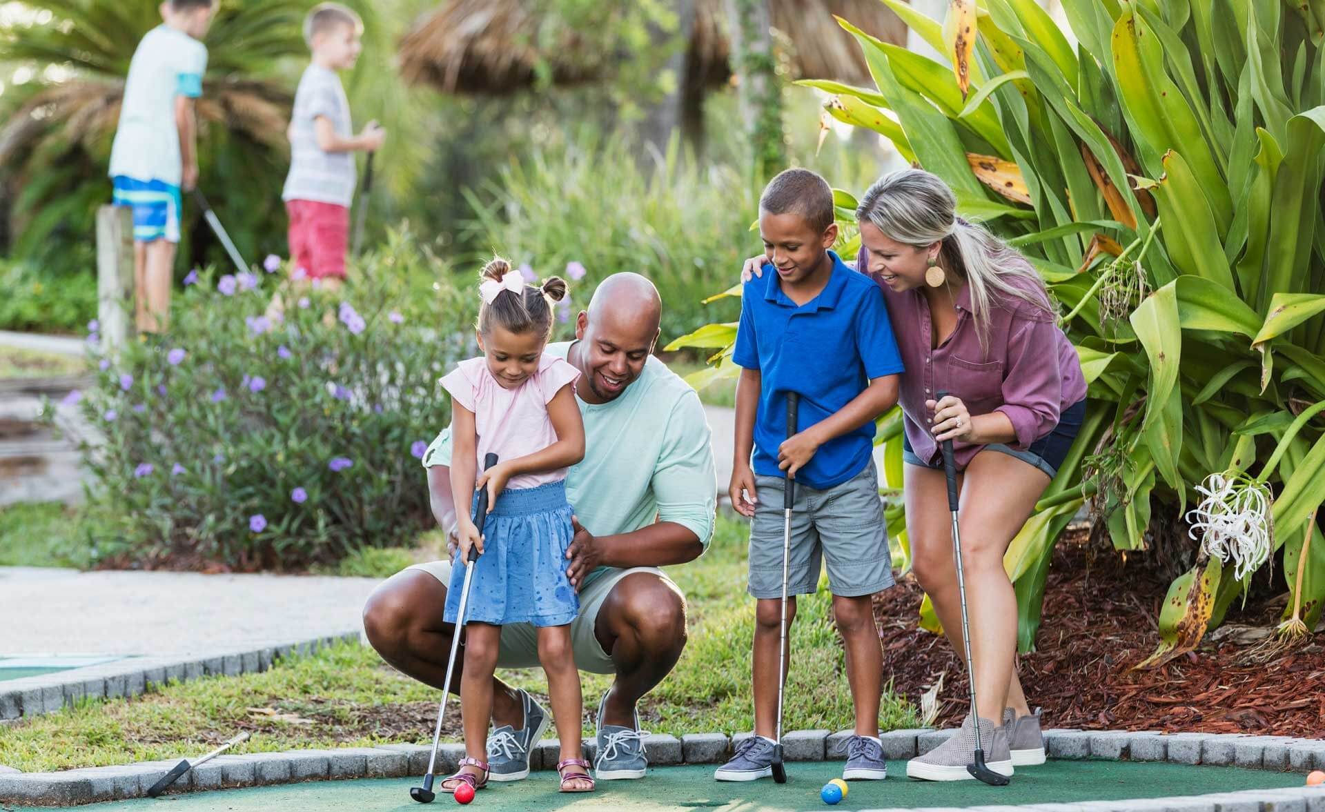 family playing mini golf