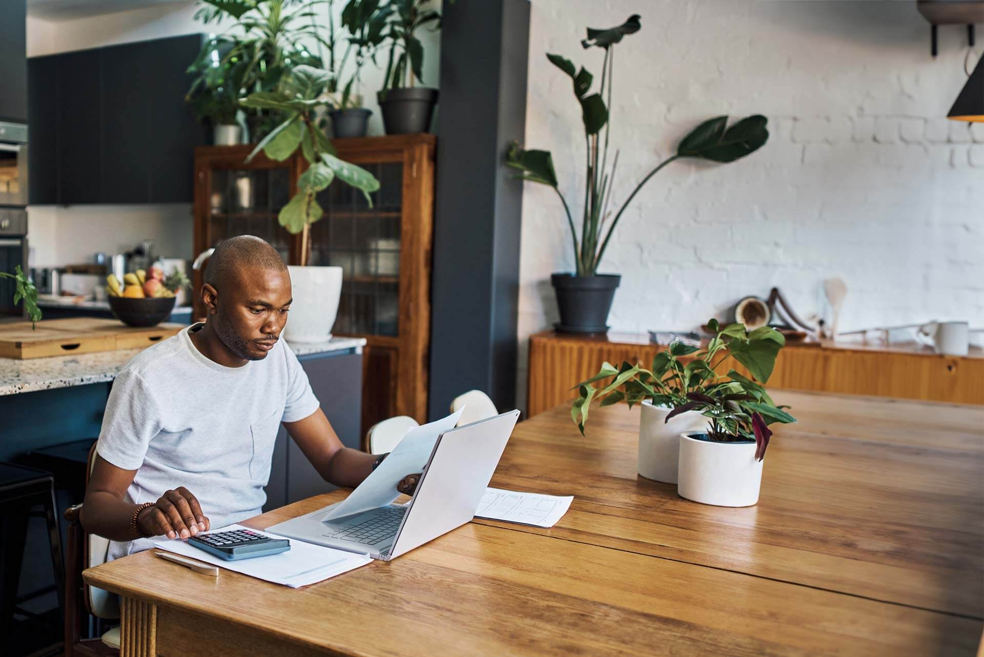 A man at his desk reviewing personal loans.